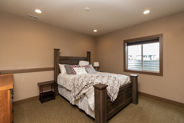 bedroom featuring dark colored carpet