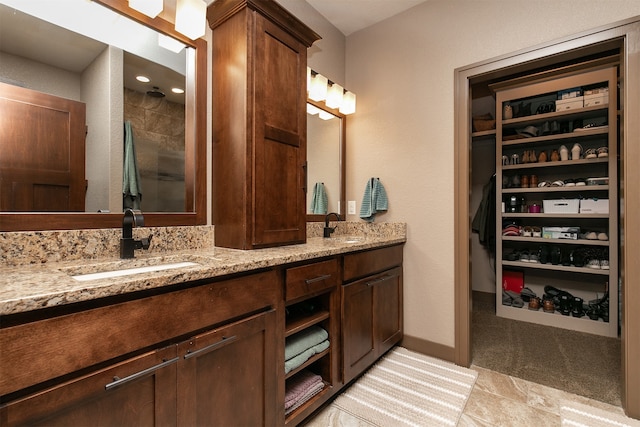 bathroom with walk in shower and vanity