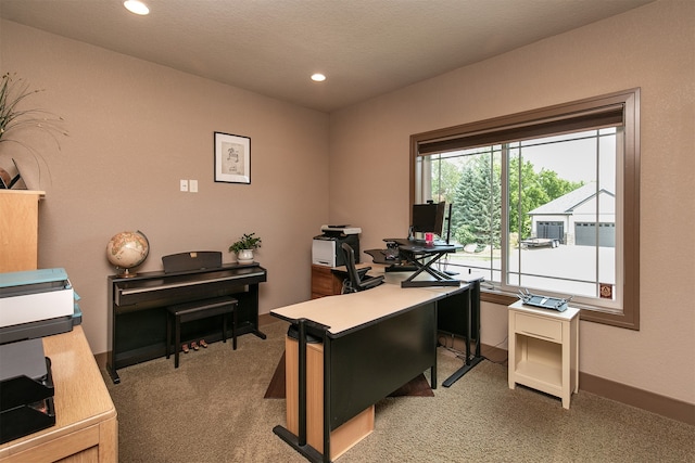 carpeted office with a textured ceiling