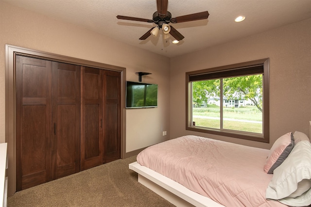 bedroom featuring a closet, ceiling fan, and carpet