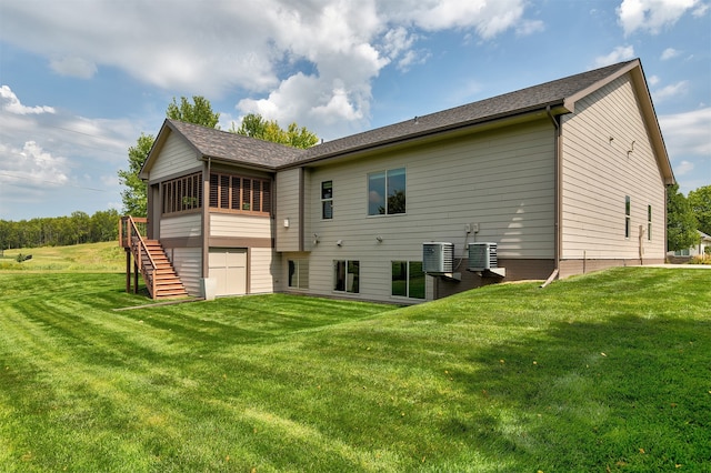 back of house featuring a lawn and central AC