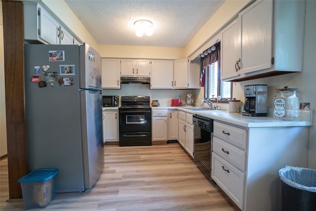 kitchen featuring a textured ceiling, black appliances, sink, white cabinetry, and light wood-type flooring