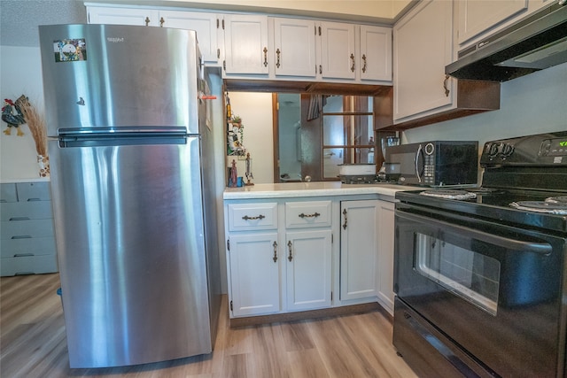 kitchen with black appliances, white cabinetry, light hardwood / wood-style flooring, and a textured ceiling