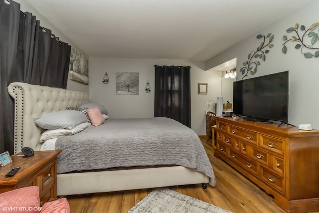 bedroom with hardwood / wood-style flooring