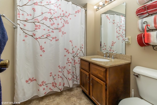 bathroom with vanity, toilet, and walk in shower