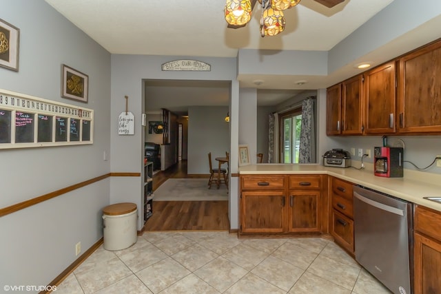 kitchen with stainless steel dishwasher, ceiling fan, and light tile patterned flooring