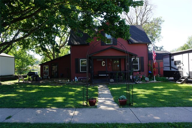 view of front of property with a porch and a front lawn