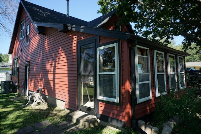 view of side of home with central AC unit