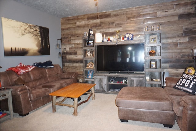 living room featuring carpet, wood walls, and a textured ceiling