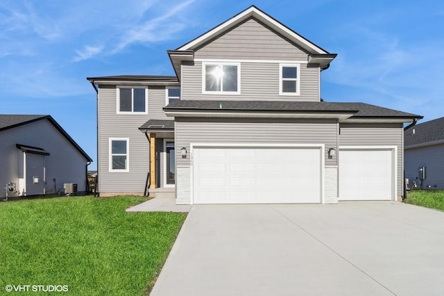 view of property featuring a front lawn and a garage