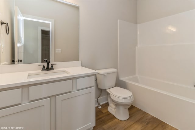 full bathroom featuring toilet, vanity, washtub / shower combination, and hardwood / wood-style flooring