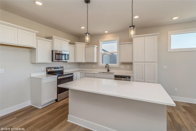 kitchen with sink, white cabinetry, a center island, and stainless steel appliances