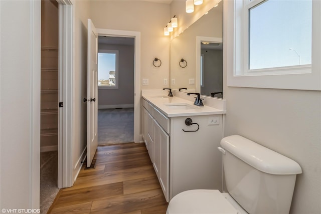 bathroom featuring toilet, vanity, and hardwood / wood-style flooring