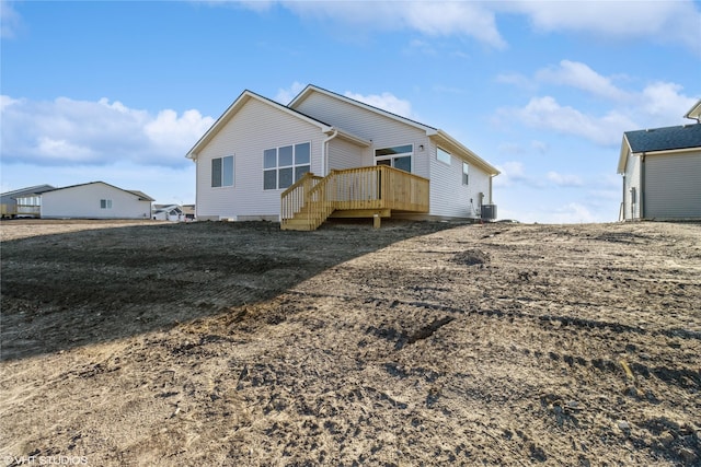 back of property with central AC unit and a wooden deck