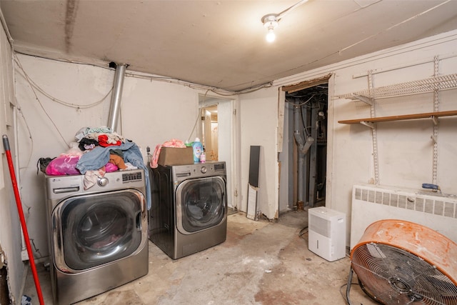 laundry room featuring washing machine and clothes dryer and radiator