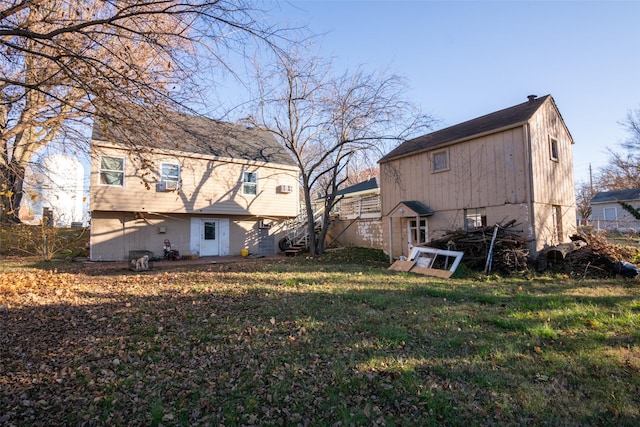 rear view of house with a yard