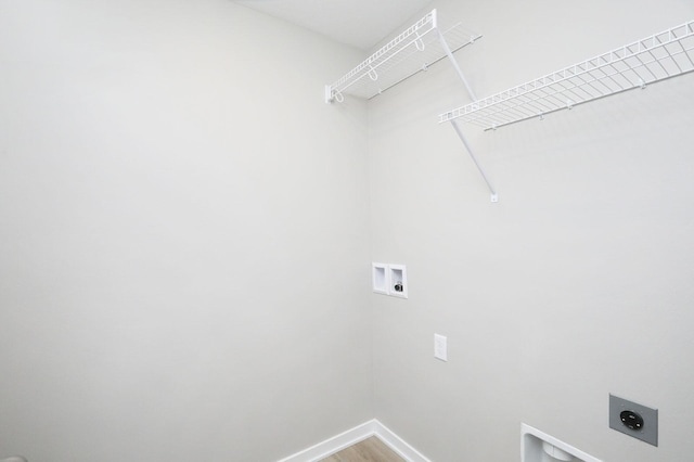 clothes washing area featuring laundry area, washer hookup, baseboards, light wood-type flooring, and electric dryer hookup