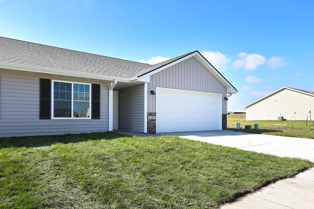 ranch-style house featuring a shingled roof, a front yard, concrete driveway, and an attached garage