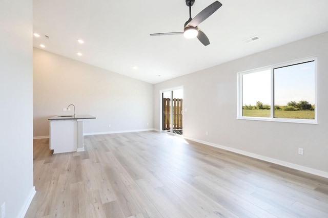 unfurnished living room with ceiling fan, recessed lighting, visible vents, baseboards, and light wood-type flooring