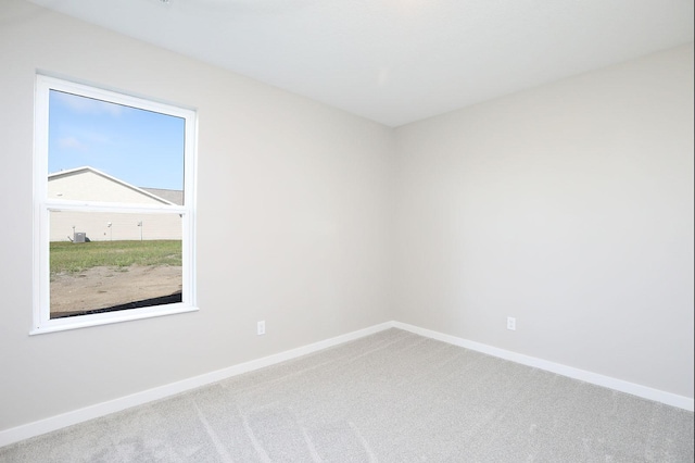 empty room with carpet floors and baseboards