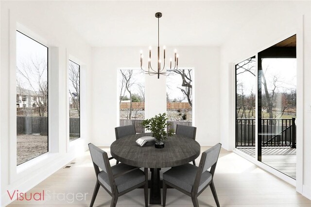 dining area featuring light hardwood / wood-style flooring and an inviting chandelier