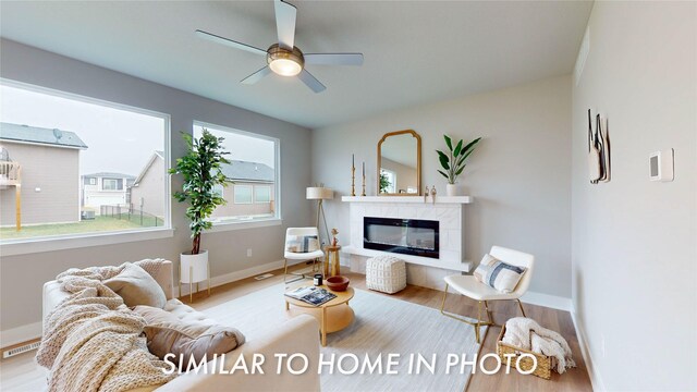 2231 Chan Dr, Adel, IA 50003 - living room with wood finished floors, a fireplace, and a ceiling fan