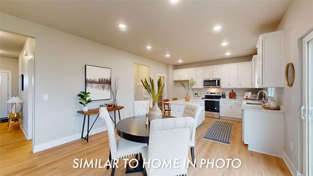 2231 Chan Dr, Adel, IA 50003 - dining area with light wood finished floors and recessed lighting