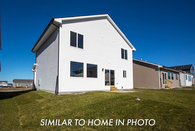 rear view of property with a yard