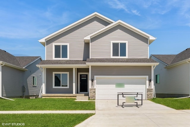2231 Chan Dr, Adel, IA 50003 - view of front of house featuring driveway, a garage, a front yard, and stone siding