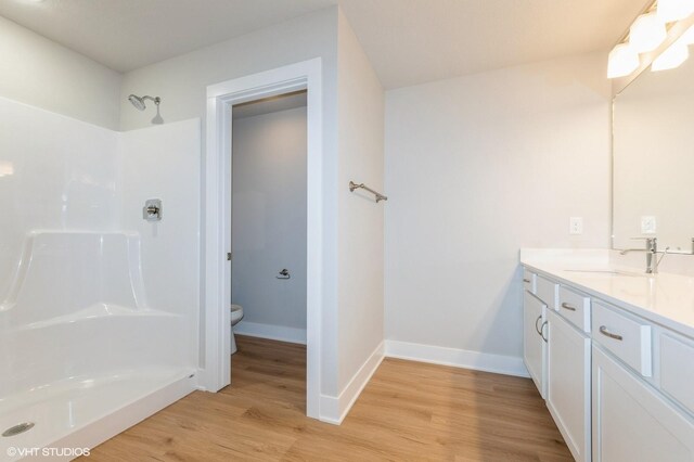 2231 Chan Dr, Adel, IA 50003 - full bath with wood finished floors, vanity, and a shower