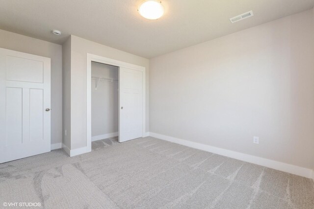 2231 Chan Dr, Adel, IA 50003 - unfurnished bedroom featuring light carpet and a closet