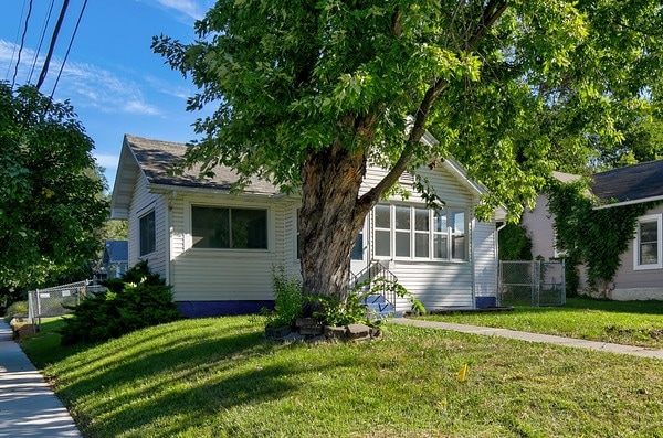 obstructed view of property with a front yard