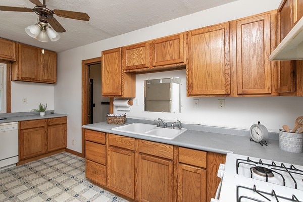 kitchen with ceiling fan, white appliances, and sink