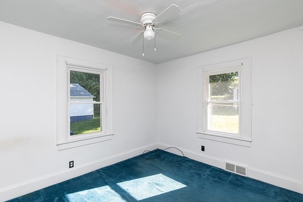 empty room with carpet and ceiling fan