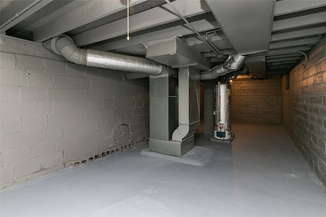 basement featuring water heater and heating unit