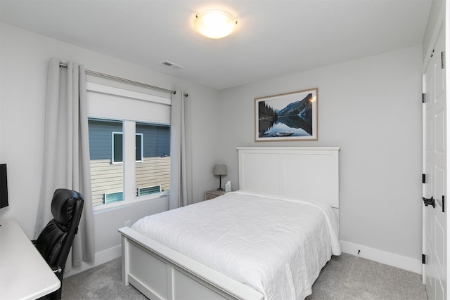 bedroom featuring light carpet