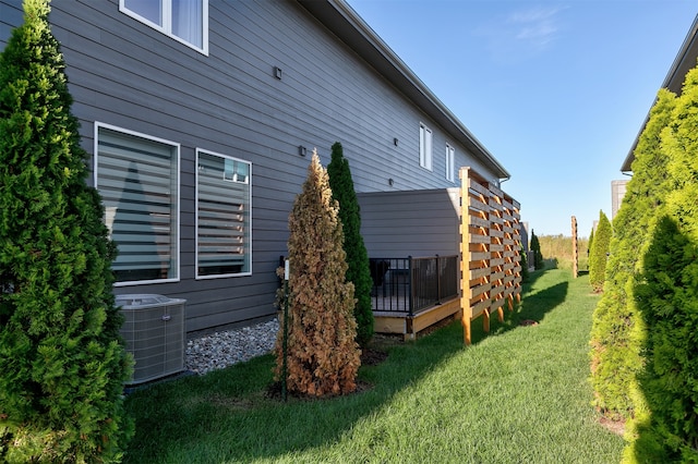 view of home's exterior with cooling unit, a lawn, and a pergola