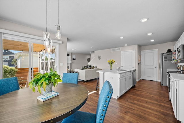 dining room featuring recessed lighting, visible vents, and dark wood-style flooring