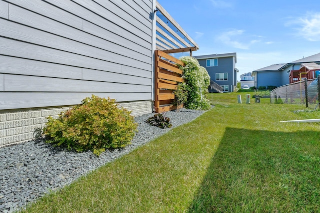 view of yard featuring stairs, fence, and a residential view