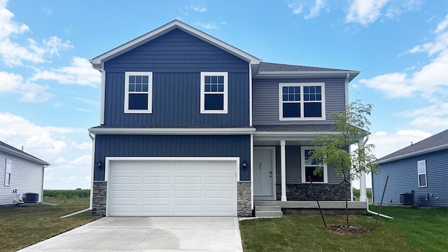 view of front of home with a front lawn, central air condition unit, covered porch, and stone siding