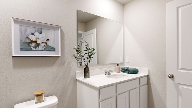 bathroom with toilet and vanity