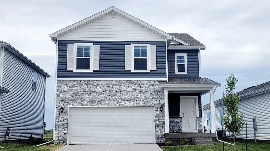 view of front facade with a garage and a front lawn