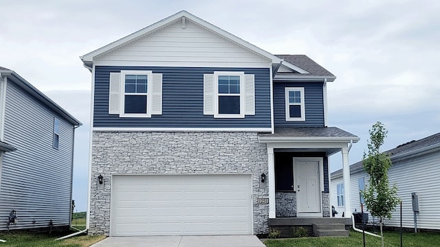 view of front of house with stone siding, concrete driveway, and a garage