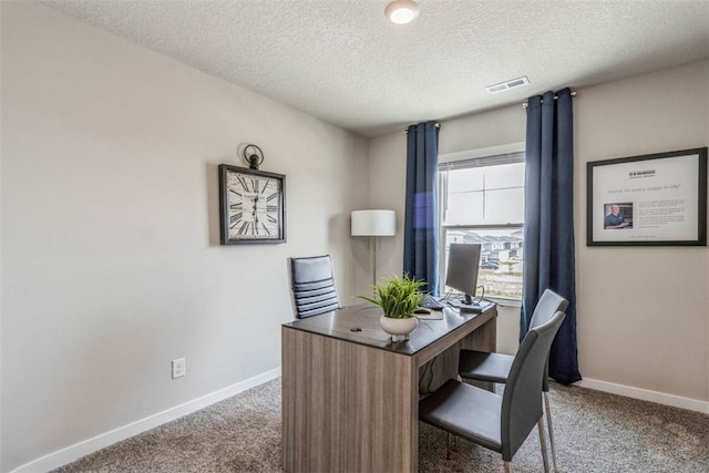 home office featuring carpet flooring and a textured ceiling