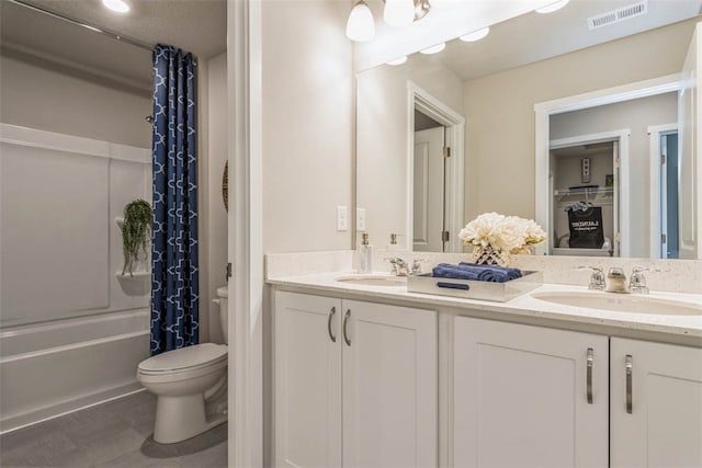 full bathroom featuring shower / bath combination with curtain, vanity, and toilet