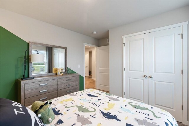 bedroom featuring light hardwood / wood-style flooring and a closet