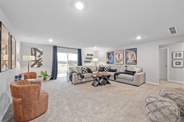 carpeted living area featuring baseboards, visible vents, and recessed lighting