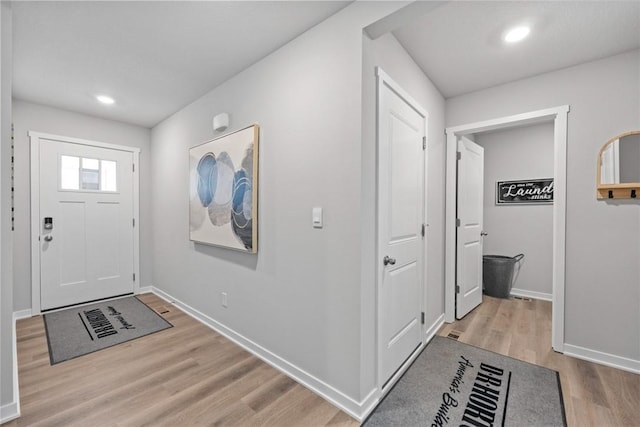 foyer entrance featuring recessed lighting, baseboards, and wood finished floors