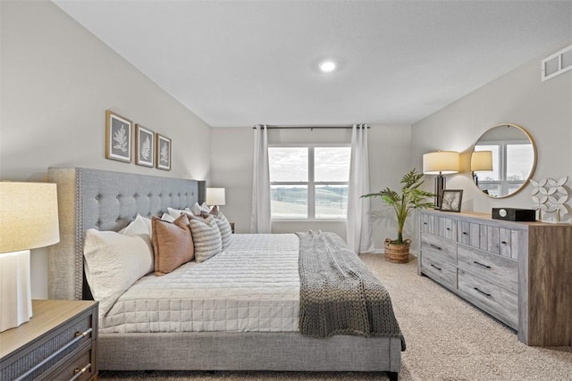 bedroom with light carpet and visible vents