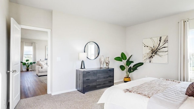 carpeted bedroom featuring baseboards